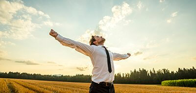 Thankful Businessman with Open Arms at the Field