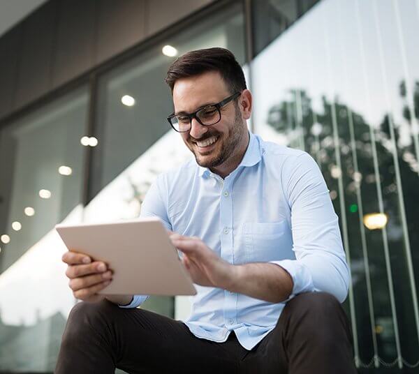 Businessman having tablet and phone at hand